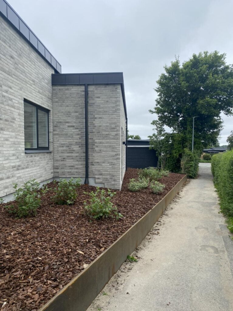 Moderne hus med havebed og sti